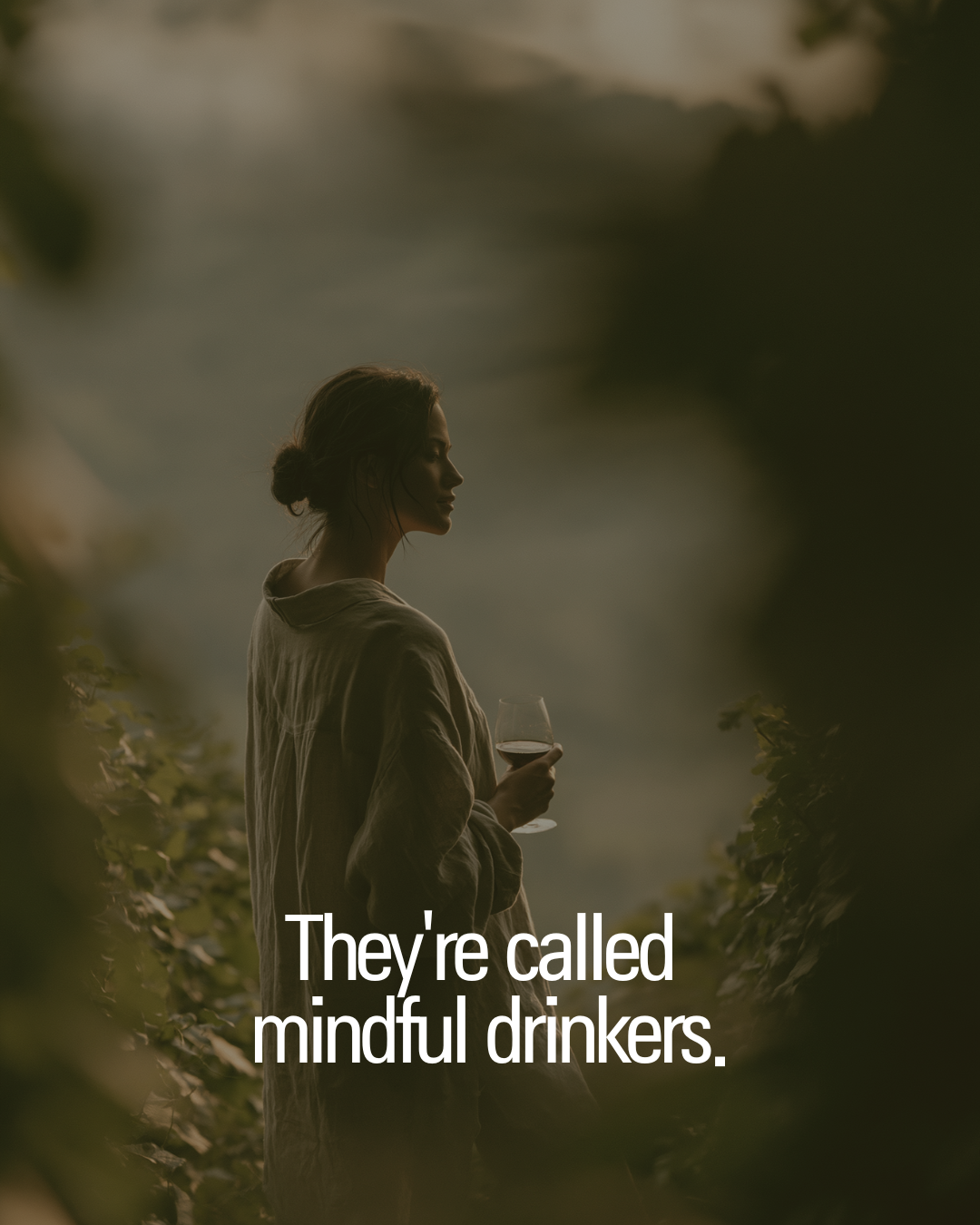 Mindful wine drinker standing in a vineyard.